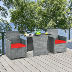 3 Piece Patio Wicker Dining Set, 2 Grey Armchairs Rated 350 lb with Red Cushions that Tuck Under a 41 in Glass Top Table