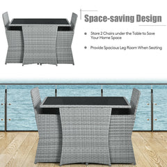 3 Piece Patio Wicker Dining Set, 2 Grey Armchairs Rated 350 lb with Red Cushions that Tuck Under a 41 in Glass Top Table